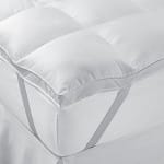 Close-up of white pillow and bedding in a college dorm room.
