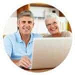Happy senior couple discussing retirement plans with advisor.