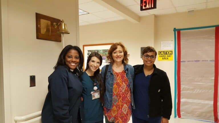 Group of diverse professionals smiling in office setting.