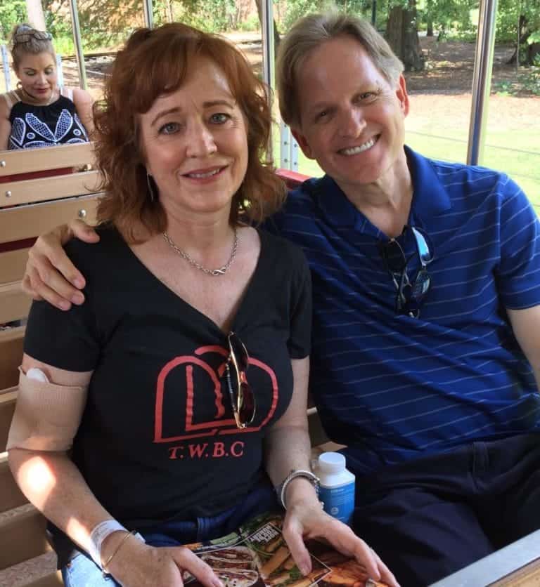 Rachael and a man smiling at an outdoor event, Christian Financial Advisors.