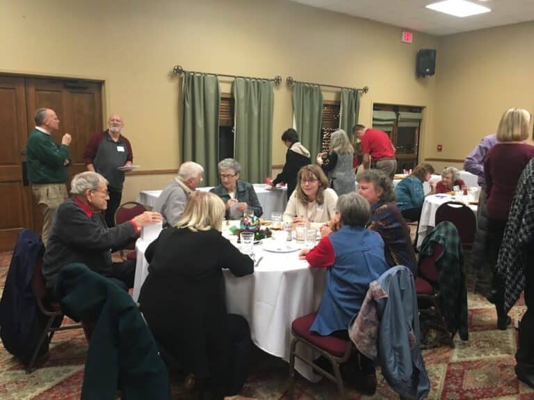 Group of people enjoying Christmas party at Christian Financial Advisors 2018 event.