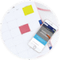 circular icon with phone sitting on top of a planner
