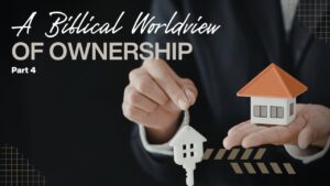 Businessman holding a house model and keys for financial planning.
